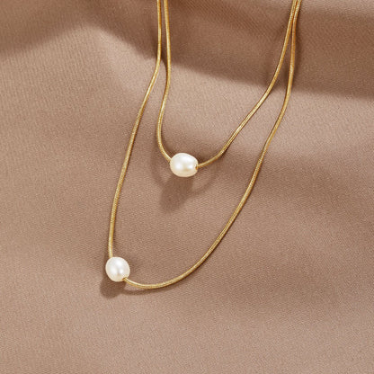 Sabina – Collana dorata a doppio strato con pietra scura